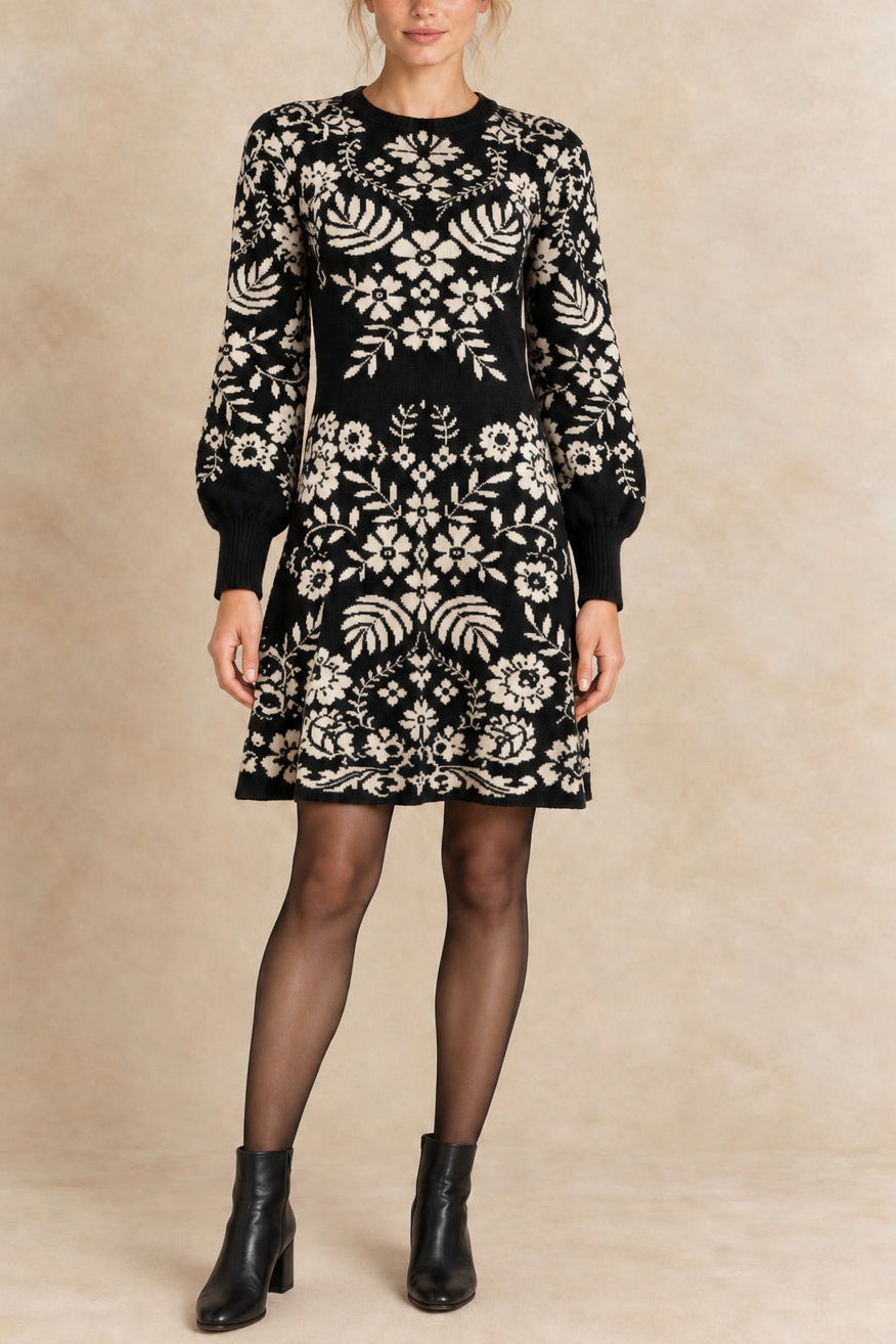 Léonie black and ivory botanical knit dress front view with semi-opaque tights and black ankle boots.