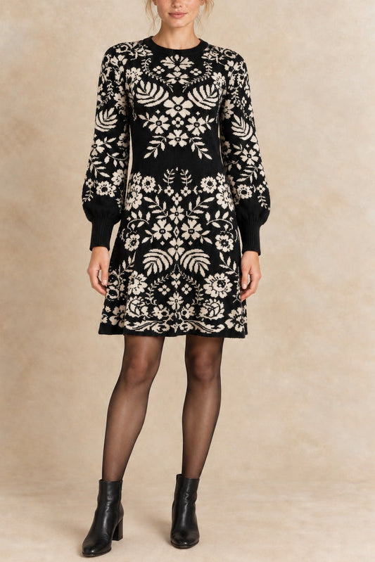 Léonie black and ivory botanical knit dress front view with semi-opaque tights and black ankle boots.